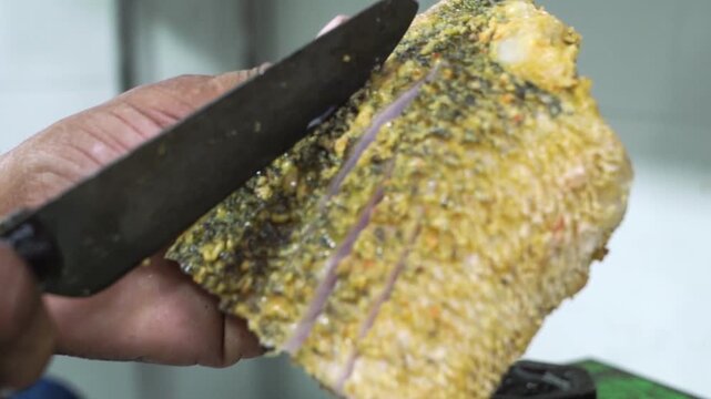 Fresh fish fillet prepared with shallow cuts across the skin to help absorb marinade and spices.