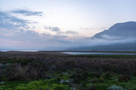 delicate fog hovering below Klein Mountains and lagoon, Stanford, South Africa
