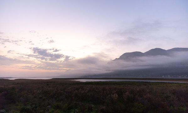 delicate fog hovering below Klein Mountains and lagoon, Stanford, South Africa
