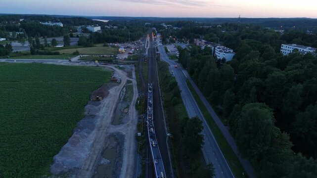 aerial view of a passenger train changing tracks while moving through a railway junction showing dynamic rail transportation and precise railway infrastructure from above