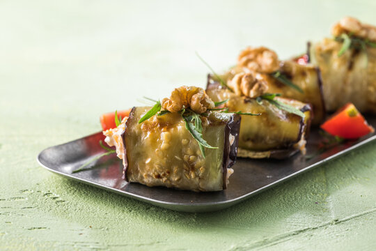 Appetizer - eggplant rolls stuffed with creme cheese, garlic and nuts, tomatoes.