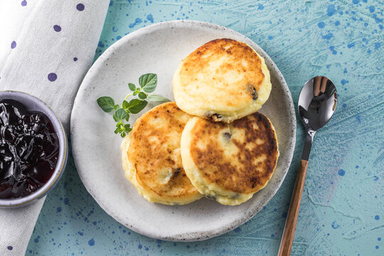 Syrnyki, Sunday breakfast with cheesecake, jam. Cottage cheese pancakes or curd fritters decorated  jam