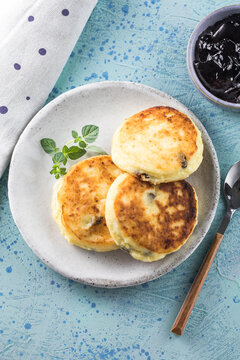 Sunday breakfast with cheesecake, jam. Cottage cheese pancakes or curd fritters decorated  jam