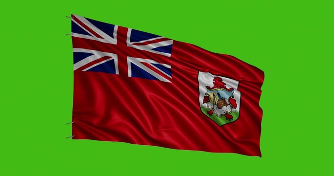 Bermuda flag waving against a green background during a sunny day