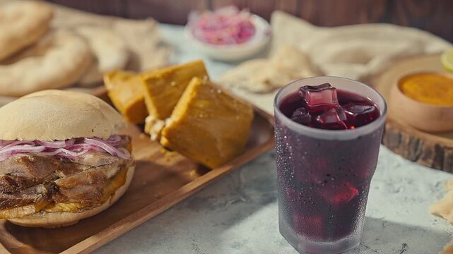 Refreshing Chicha Morada alongside a Peruvian Pan con Chicharr&oacute;n Combo