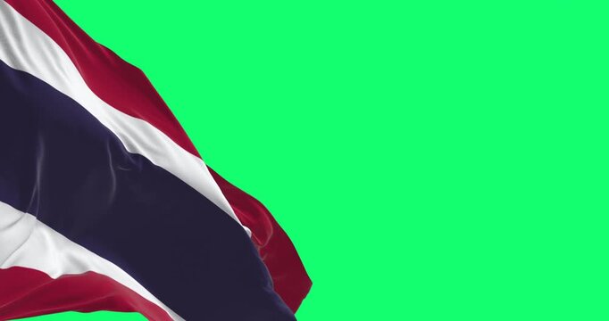 Thailand national flag waving in the wind isolated on green background