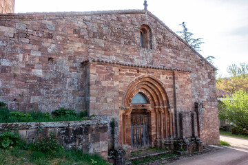 Romanesque church of San Millan de Lara, 12th century ashlar stone temple facade featuring a main portal with concentric archivolts and carved capitals. San Millan de Lara. Burgos, Spain © Nandi Estévez