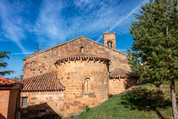 Romanesque church of San Millan de Lara, 12th century ashlar stone temple with semicircular apse, corbels, curved window with small columns, and square bell gable, located in San Millan de Lara,Burgos © Nandi Estévez