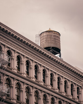 Historic Cast Iron Building with Rooftop Water Tower in New York City
