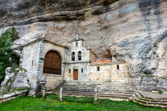 Hermitage of San Tirso and San Bernabe built into the limestone cave walls of the Ojo Guarena karst complex, Merindad de Sotoscueva, Burgos, Castile and Leon, Spain