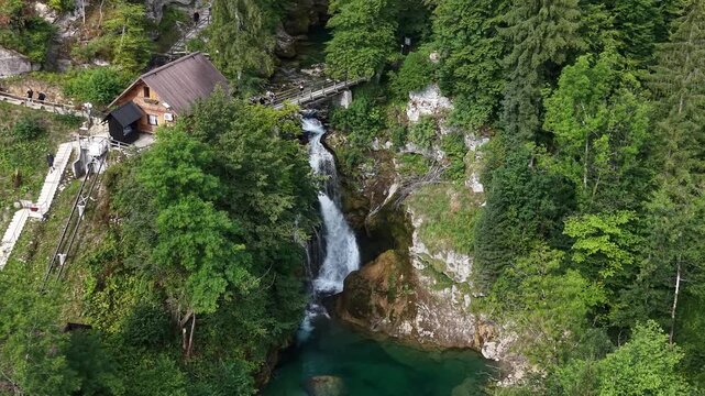 Flight over Sum waterfall and wooden walkways in Vintgar Gorge, Slovenia