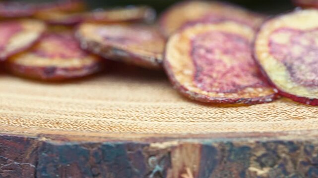 Extreme close-up of crispy fried native Peruvian purple potato chips.