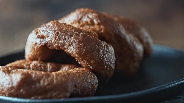 Traditional Peruvian picarones with sweet chancaca syrup drizzle.