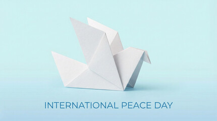 Obraz premium Minimalist White Dove Origami Peace Symbol. Single geometric paper dove in pure white against soft blue gradient representing international peace day