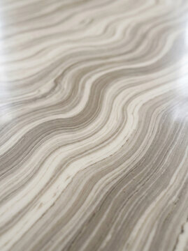 Elegant taupe and off-white marble texture background with soft fluid organic waves