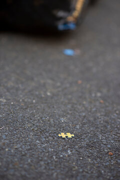Yellow puzzle piece on asphalt surface conceptualizing incompleteness and missing parts
