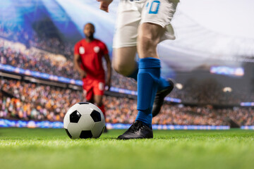 Striker runs forward and kicks the soccer ball toward goal using dynamic footwork, pursued by an...