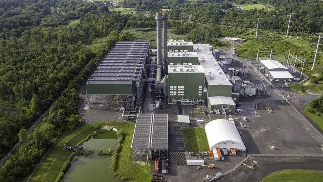 Aerial view of Cricket Valley Energy Center featuring power plant infrastructure, high-voltage electrical substation, and steel support structures in Dover Plains, New York, United States.