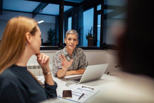 Female manager leading team discussion in modern office
