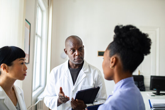 Medical team discussing patient case in clinic office