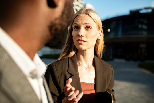 Business colleagues discussing project outside modern office