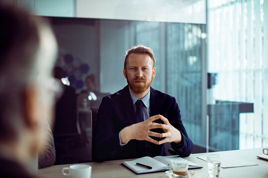 Confident manager leading discussion in modern office