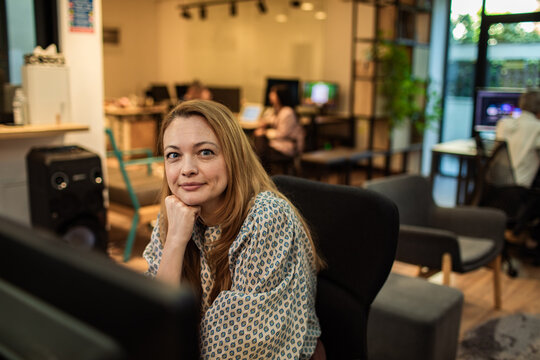 Portrait of confident woman in modern coworking office