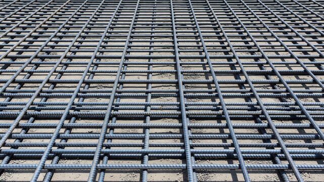 A close-up view of a metal grid structure made of reinforced steel bars for construction projects.