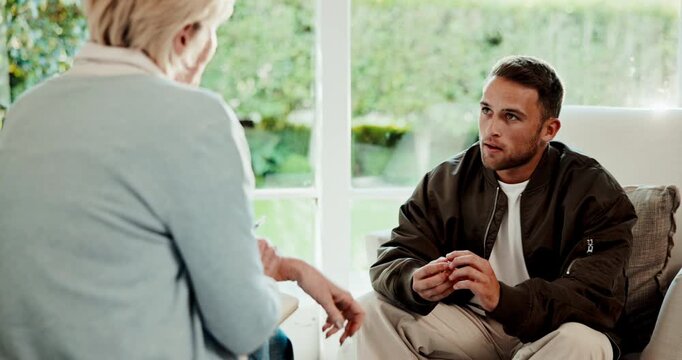 Wedding ring, psychology and man with therapist in office for support or advice on divorce. Talking, breakup and patient with psychiatrist for counseling session on mental health evaluation in clinic