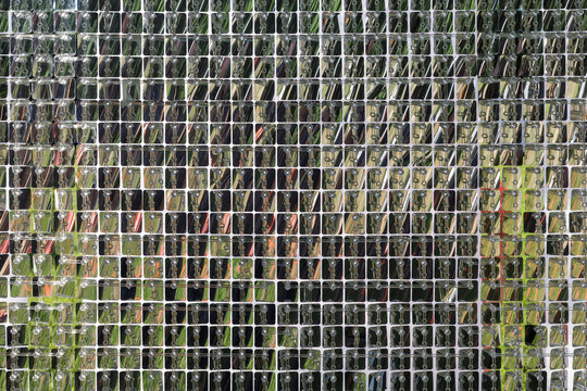 Reflective silver sequin wall mosaic, geometric shimmering background texture for luxury event backdrop, disco decor, futuristic design and modern architecture.