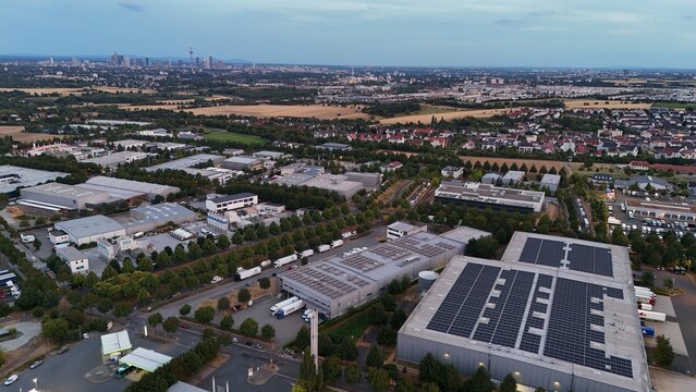 Aerial view of Iron Mountain Data Centers FRA-2 with industrial buildings, solar panels, and trucks in an urban setting, Frankfurt am Main, Hessen, Germany.