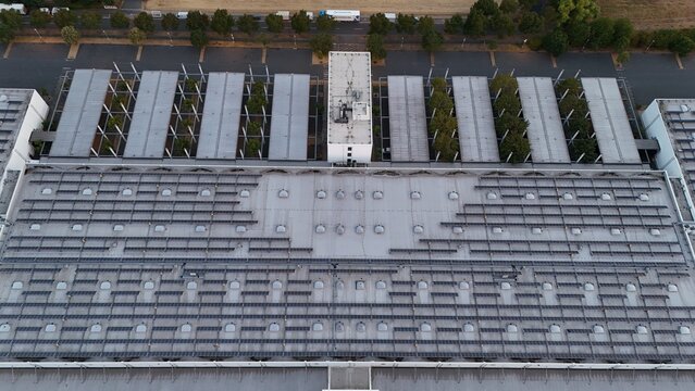 Aerial view of Iron Mountain Data Centers FRA-2 with extensive rooftop solar panel arrays and surrounding parking facilities in Frankfurt am Main, Hessen, Germany.