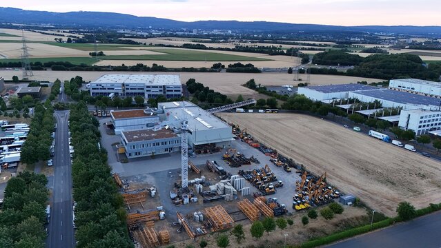 Aerial view of Iron Mountain Data Centers FRA-2 facility with surrounding industrial grounds, construction equipment, and storage areas, Frankfurt am Main, Hessen, Germany.