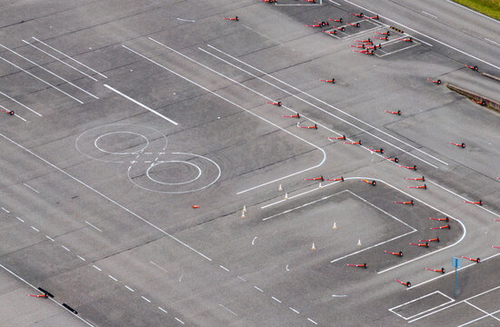 Aerial view of a driving test course with painted markings, traffic cones, and asphalt surfaces in Vilnius, Vilniaus apskritis, Lithuania.