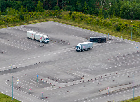 Aerial view of a driving school training ground with trucks and painted asphalt markings in Vilnius, Vilniaus apskritis, Lithuania.