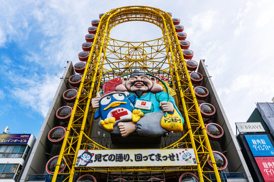 Storefront of Don Quijote in Dotonbori with the world's first oval-shaped Ferris wheel on its facade. Don Quijote Dotonbori is one of Japan's largest discount stores with over 20,000 daily visitors.