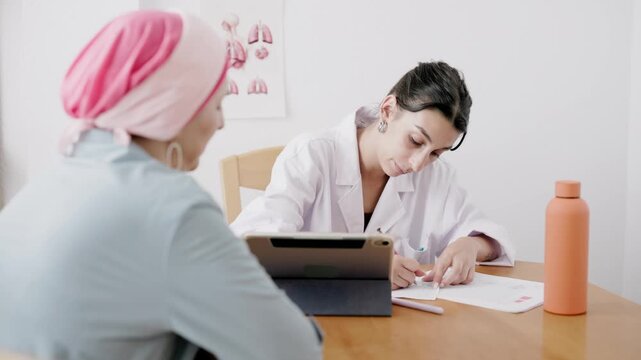 Female doctor prescribing treatment to cancer patient