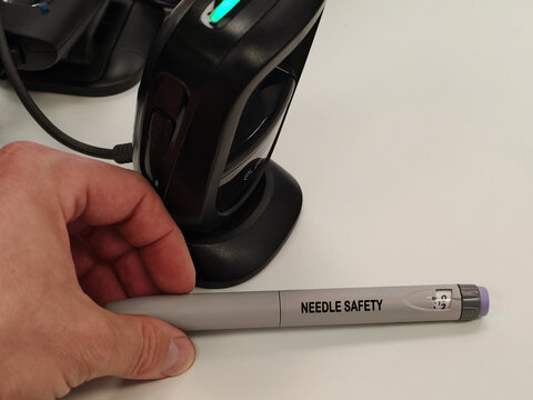 NEEDLE SAFETY pharmaceutical dosage form and drug delivery concept in a pharmacy setting with a barcode scanner behind