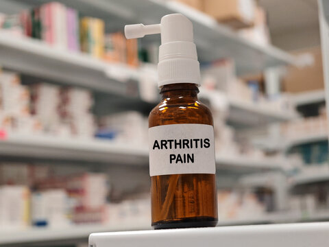 ARTHRITIS PAIN topical analgesic spray for relief of localized muscle, joint or musculoskeletal pain with pharmacy warehouse drawers in the background