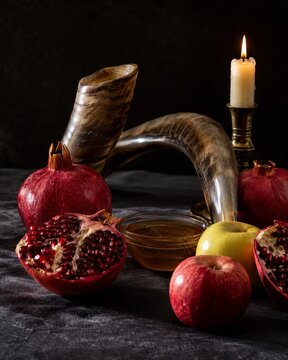 Dramatic Rosh Hashanah Still Life with Shofar Candle Apples and Pomegranates