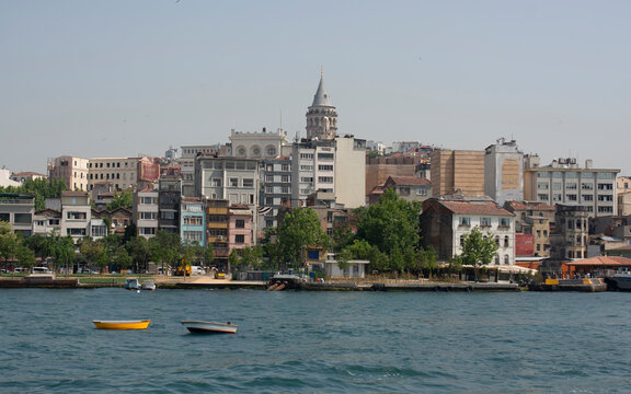 View into land across the Bosphorus of the Galata Tower and city skyline, Istanbul, Turkey