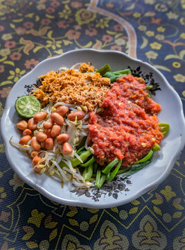 Close-up of a traditional Indonesian water spinach salad (Plecing Kangkung) with sambal from Lombok