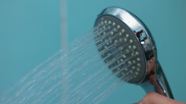 shower with water in the bathroom. Water running from shower head and faucet in the bathroom, Running shower head in tiled bathroom wall.