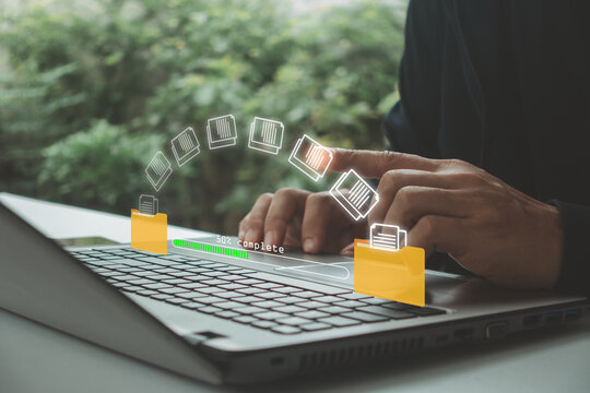 Businessman transferring digital files on laptop with virtual document management interface, presenting cloud storage, data migration, file sharing, workflow automation, secure information management.
