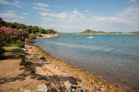 Unspoiled wild beach with boats anchored in the Aegean sea, Ayvalik, Balikesir Province, Turkey