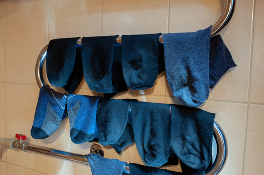 Socks are drying on radiator at home. Save energy and mone concept.