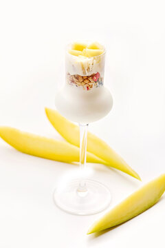 Close-up of a Greek Yogurt, Granola and Fresh Mango dessert in a luxury stemmed glass