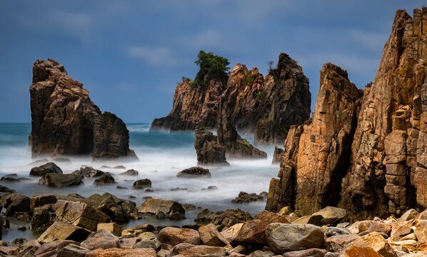 Dramatic rock formations at Sharks Teeth Beach (Gigi Hiu), Lampung,  Sumatra Island, Indonesia