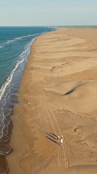 Aerial view of Mediterranean coastline and sand dunes in Ebro Delta Natural Park, Deltebre, Catalonia, Spain