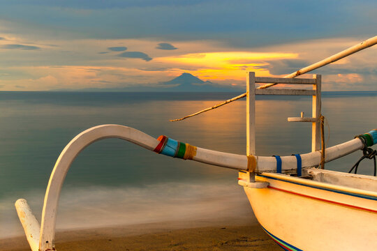 Traditional juking boat on a beach at the water's edge, Senggigi Beach, Lombok, Indonesia